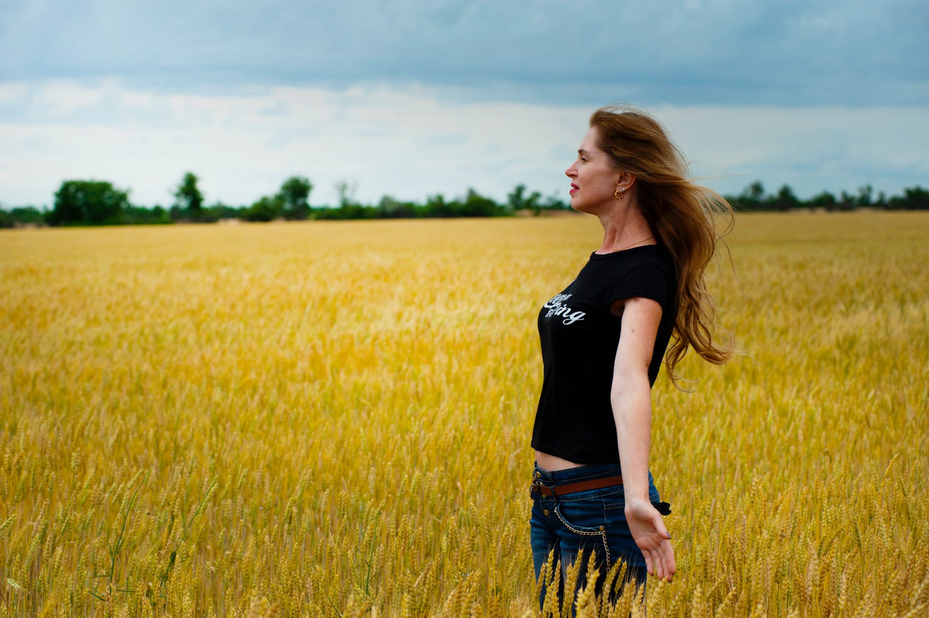 woman wearing black shirt surrounded by grass