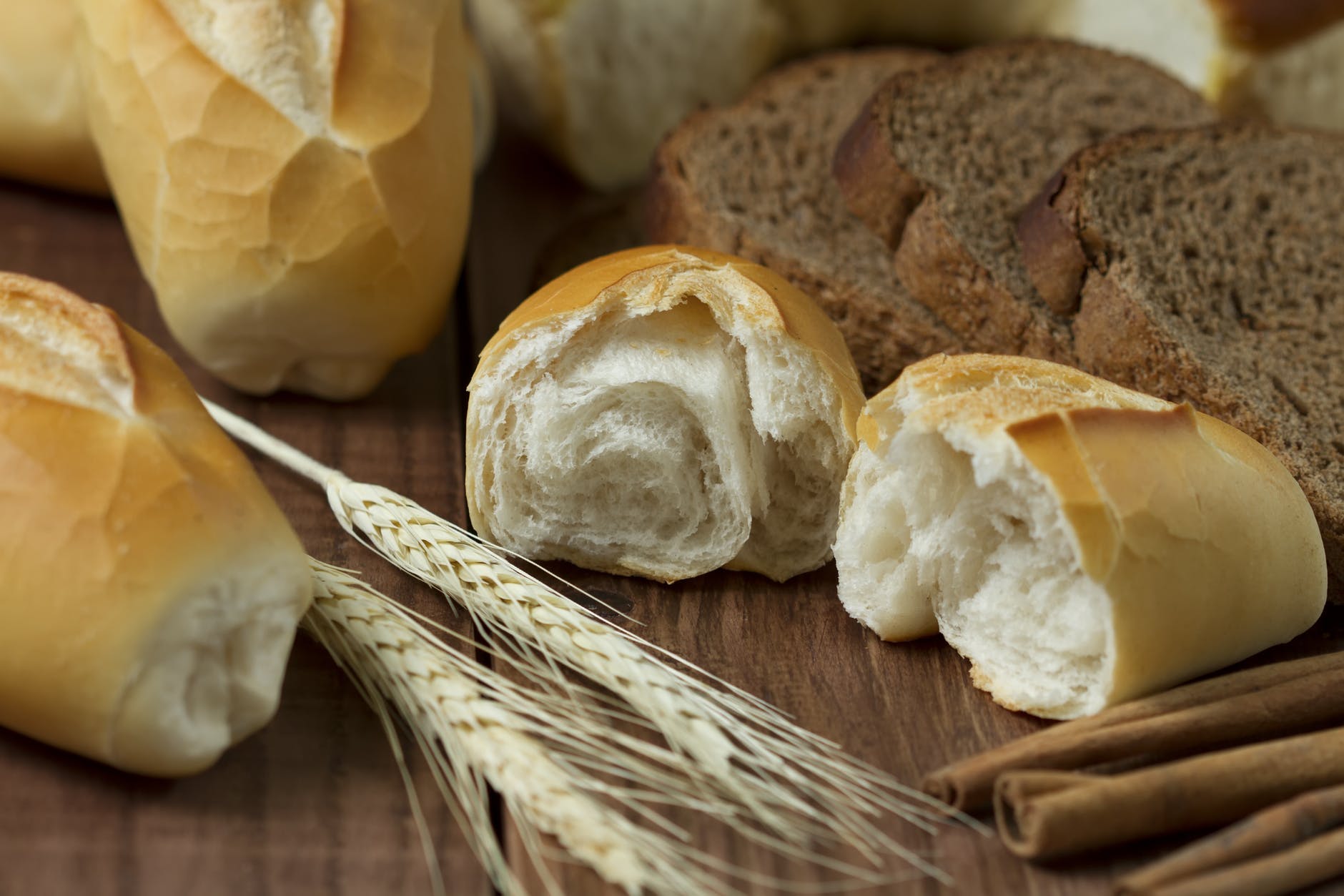 sliced bread beside wheat on table